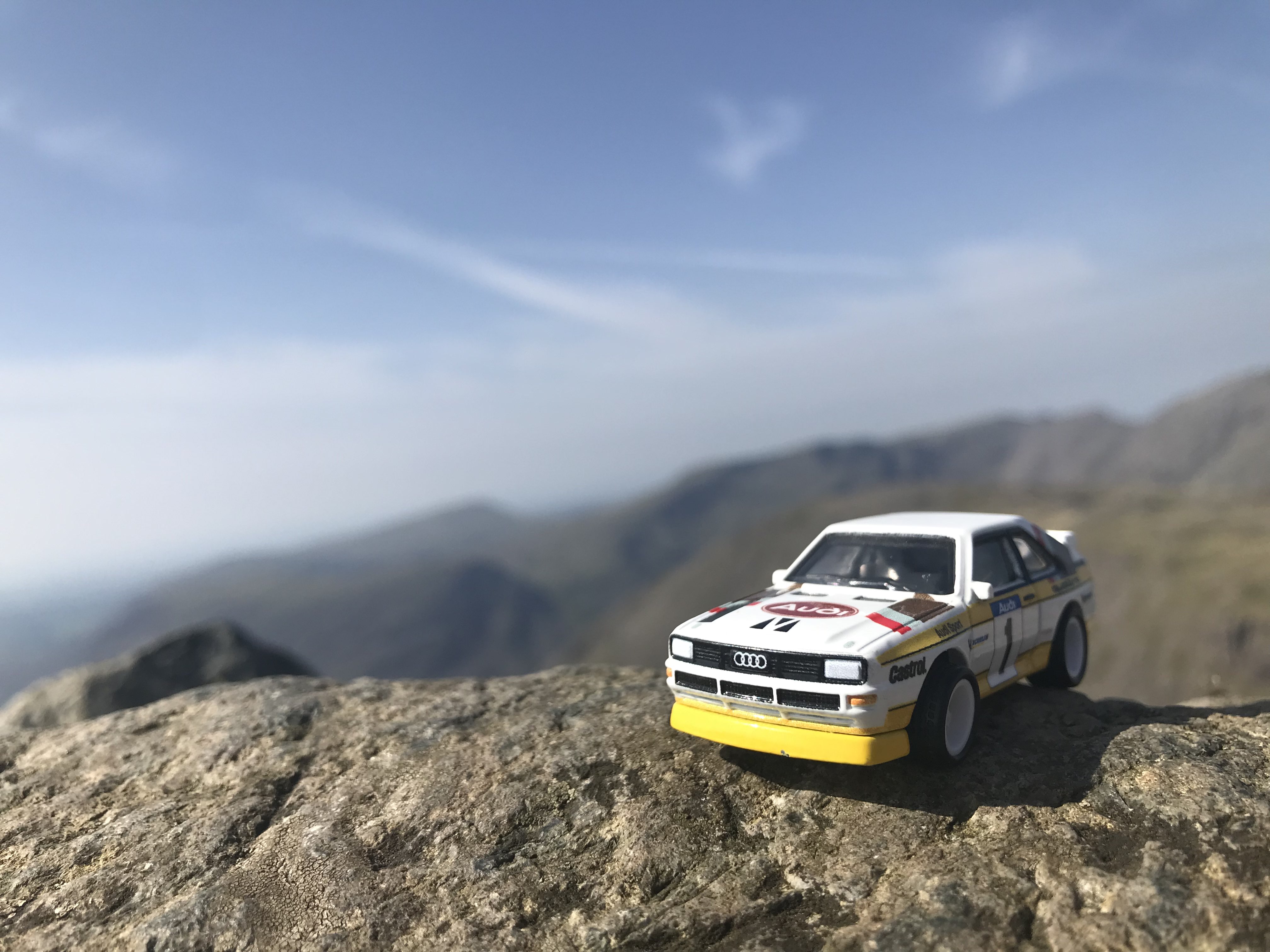 Hotwheels Grp B Rally Audi Quattro on a rock ontop of a hill. Rocky hills are seen in the background [Windows XP Install Theme / Stan Lepard - Velkommen (SM64 Soundfont)]